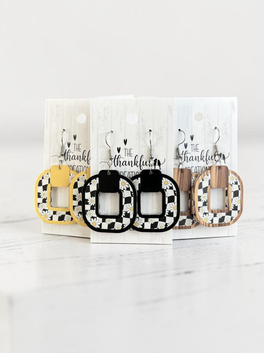 Trendy black and white checkered daisy statement earrings worn as bold everyday jewelry