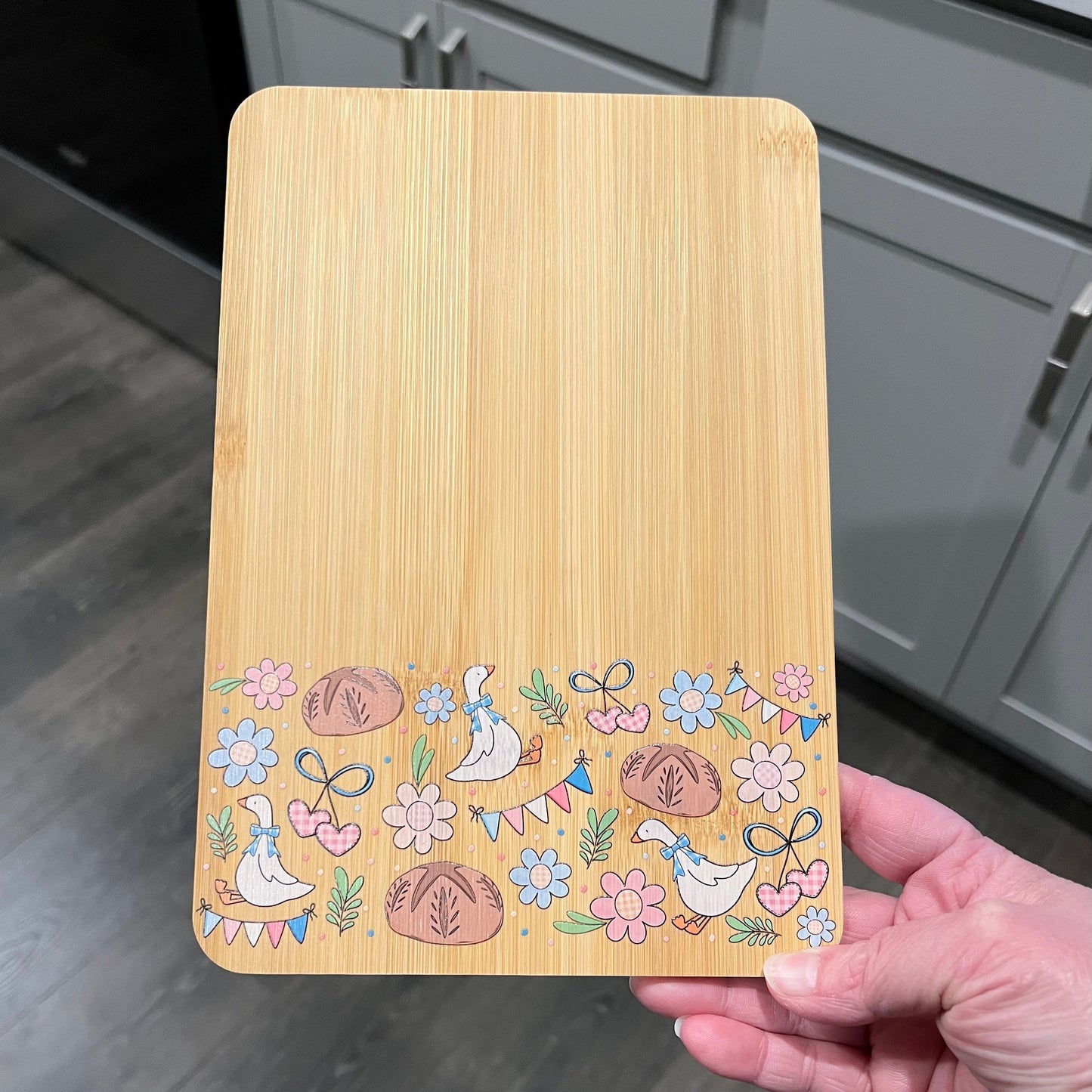cottagecore goose cutting board with sourdough bread and floral design