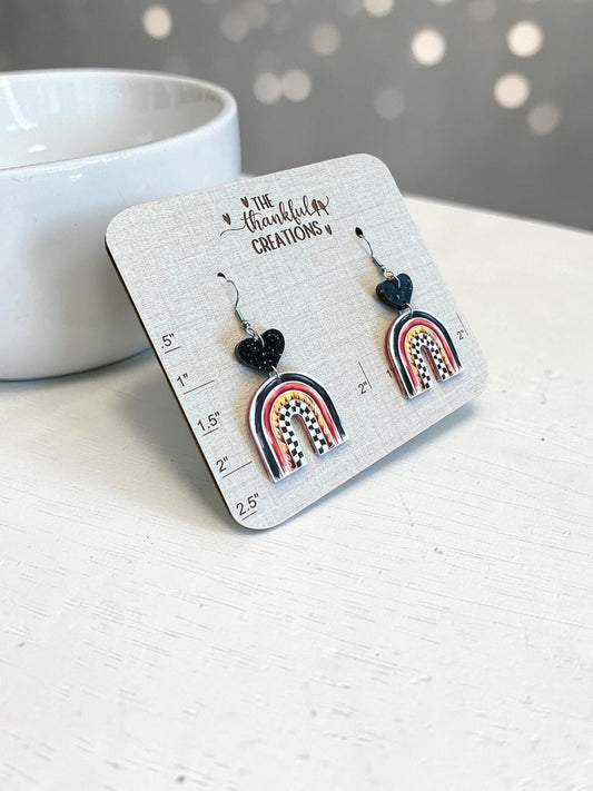 racing arch earrings with checkered flag pattern and flames, black glitter heart acrylic dangle earrings, handmade lightweight race day jewelry