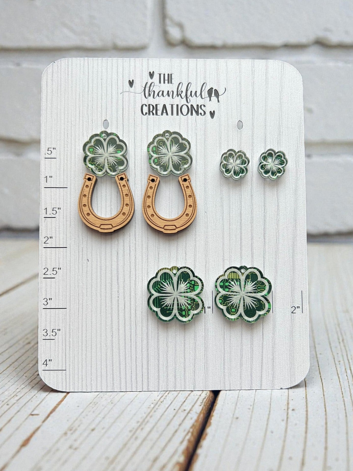 Pair of earrings on a Thankful Creations branded card with measurements.