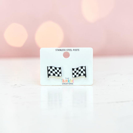 Checkered flag earrings on a branded card with a soft pink background