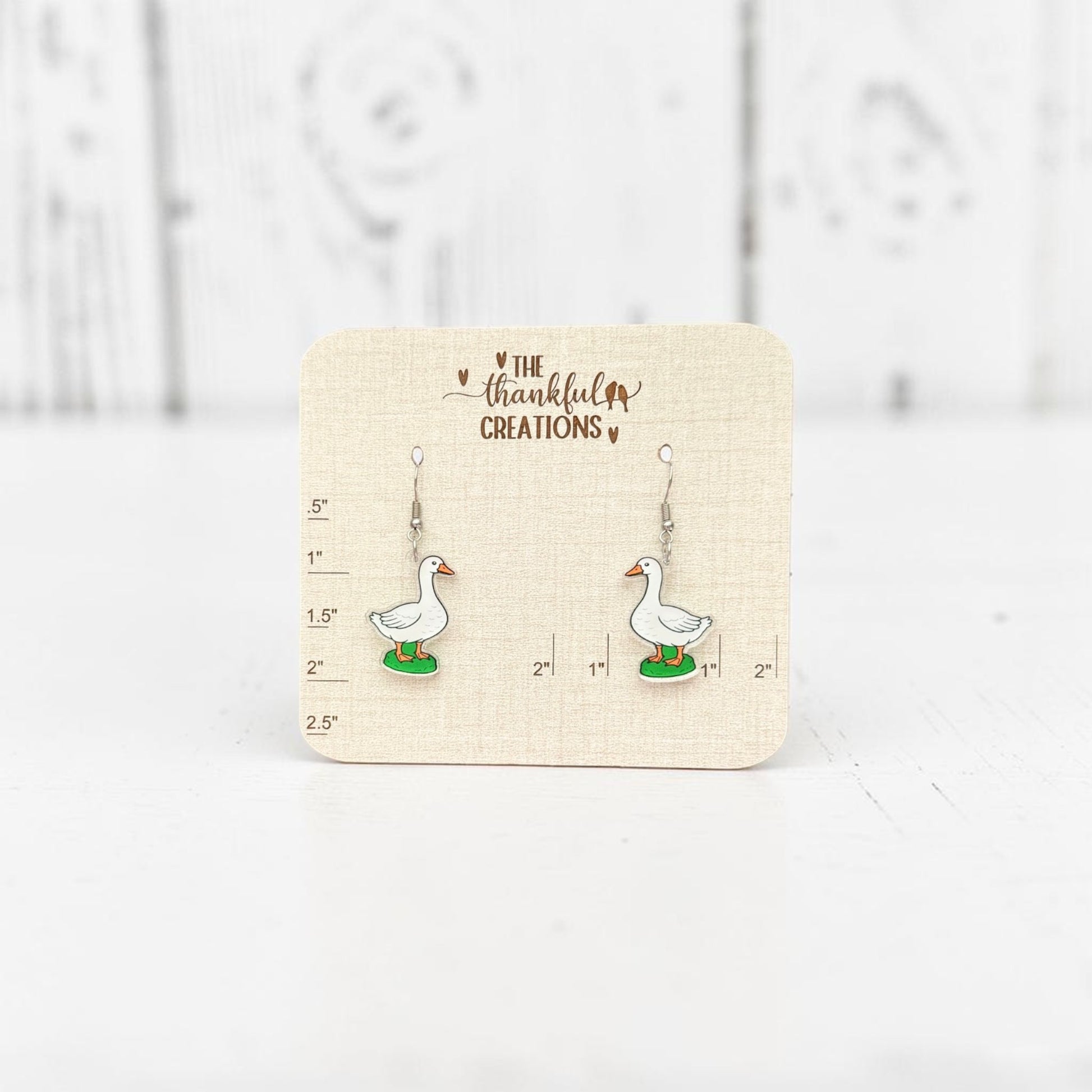 White porch goose acrylic dangle earrings on clear acrylic with stainless steel hooks, cottagecore farmhouse inspired handmade jewelry by The Thankful Creations.