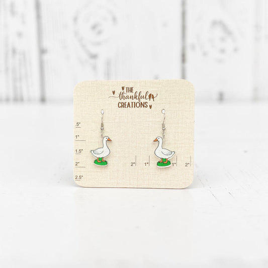 White porch goose acrylic dangle earrings on clear acrylic with stainless steel hooks, cottagecore farmhouse inspired handmade jewelry by The Thankful Creations.